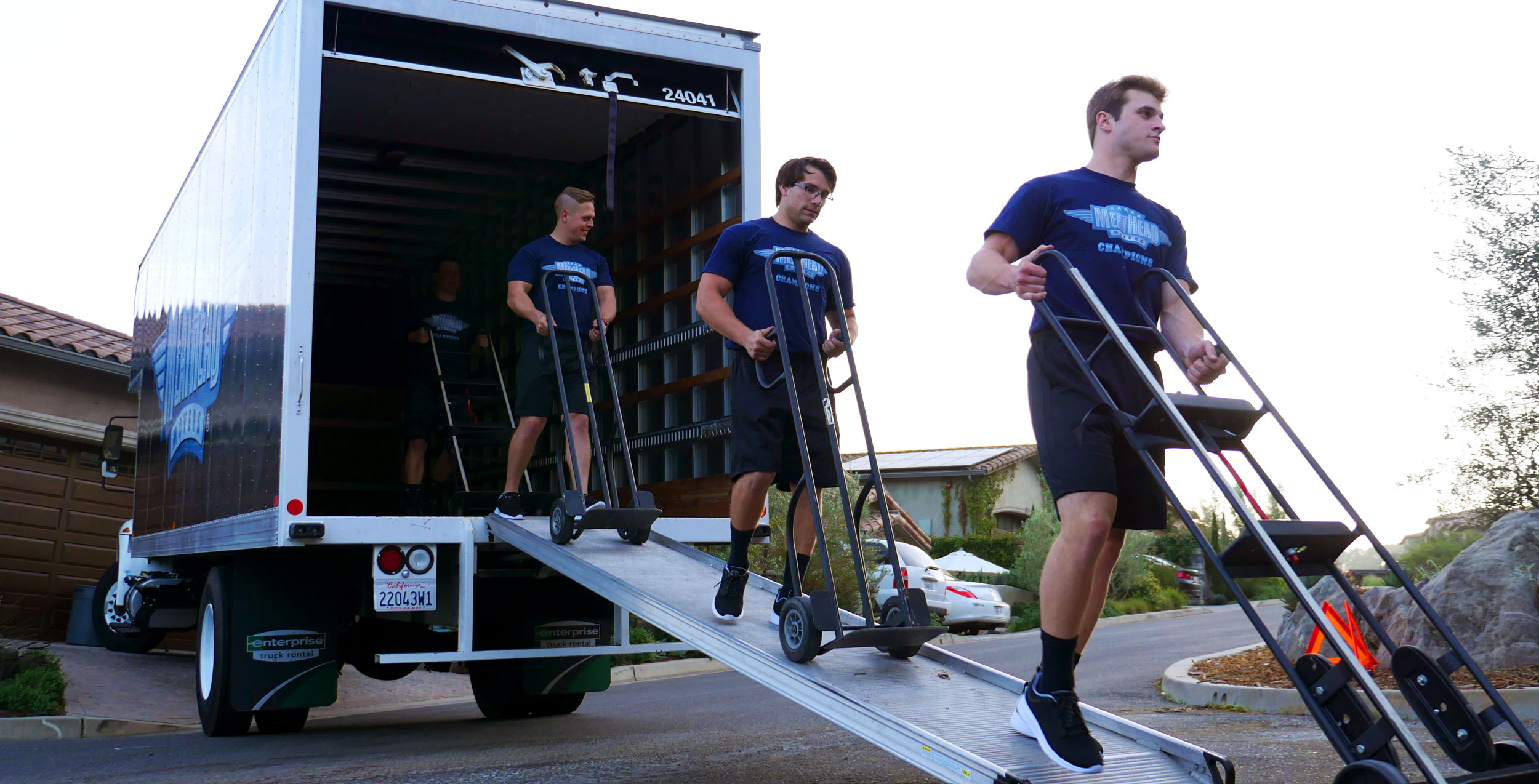 Meathead Movers walking out of a truck after loading it with boxes.